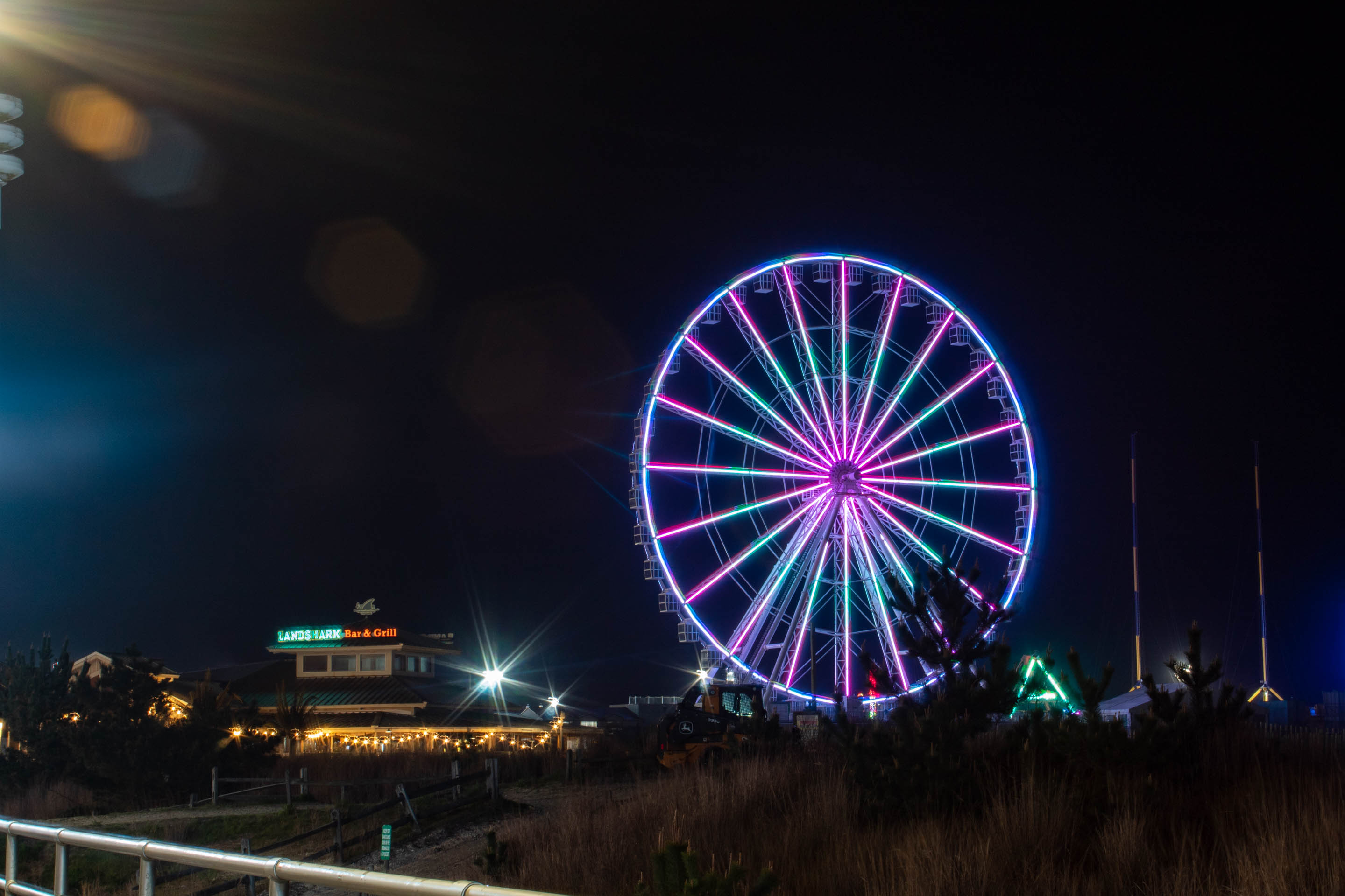 Photograph of neon purple and blue ferris wheel 
                                    on the Steel Pier in Atlantic City